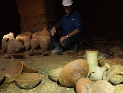 An archeologist surrounded by the ceramic work discovered in the cave in Palmachim, Israel.