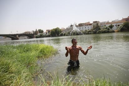 A man cools off in the Guadalquivir river in Seville. 
