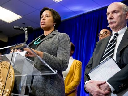 District of Columbia Mayor Muriel Bowser, accompanied by DC Council Chairman Phil Mendelson, right, speaks at a news conference in March 2020 in Washington.