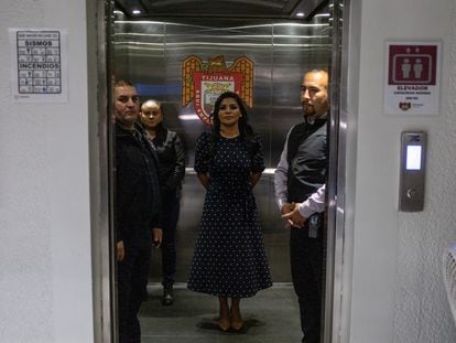 Mayor Montserrat Caballero, surrounded by members of her security detail, takes a private elevator in Tijuana’s municipal hall, in the Mexican state of Baja California.