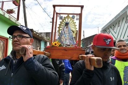 Parishioners carry an icon representing Our Lady of the Miracles of Caacupé, the church where the mass was celebrated.