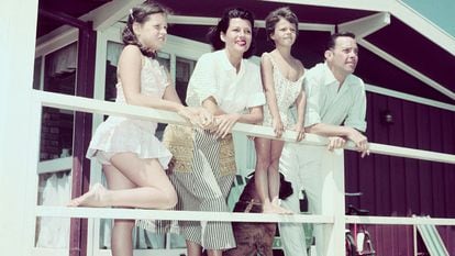 Rita Hayworth and family on a beach house balcony.