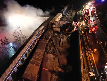 Smoke rises from trains as firefighters and rescuers operate after a collision near Larissa, Greece, early Wednesday, March 1, 2023.