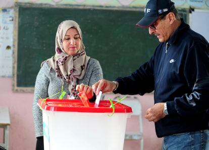 A Tunisian votes in the second round of the legislative elections in Tunis, Sunday, Jan. 29, 2023.