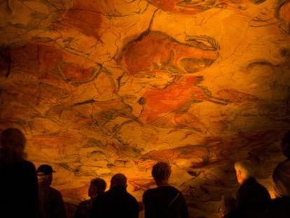 A group of visitors observes the replica of the world-famous cave paintings in Santillana del Mar.