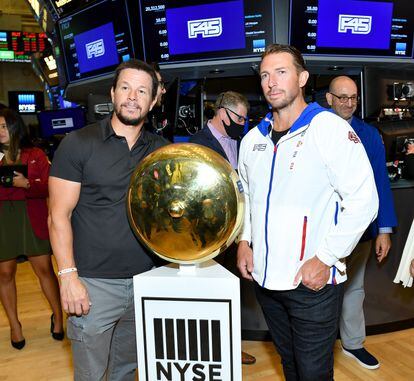 Mark Wahlberg with Adam Gilchrist, the founder of F45 Training, in the New York Stock Exchange, circa 2021.