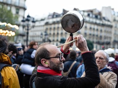 A protester bangs on a pot in Paris on April 24.