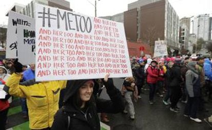 A marcher carries a sign with the popular Twitter hashtag #MeToo.