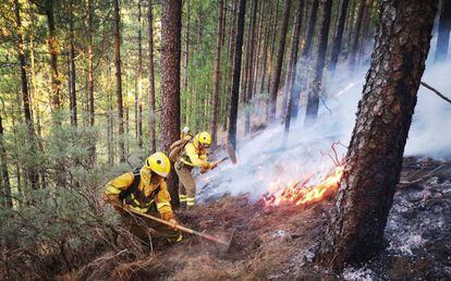 Firefighters work to put out the blaze.