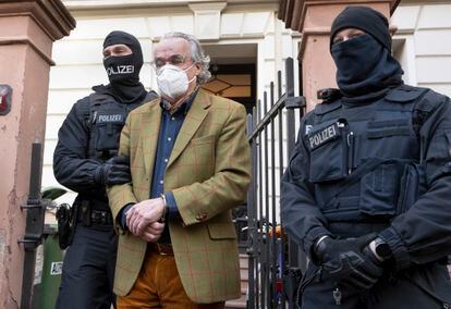 Police officers taking Heinrich XIII into custody on Wednesday from his home in Frankfurt, Germany.