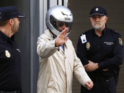 González Pacheco, wearing a motorcycle helmet, leaves court in a file photo from 2014.