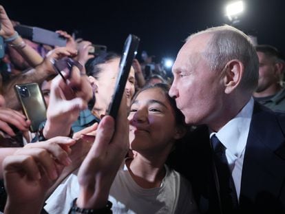 Vladimir Putin kisses a young woman on the head at a rally organized by the Kremlin in Derbent, in the Russian Republic of Dagestan, on Wednesday, June 28, 2023.