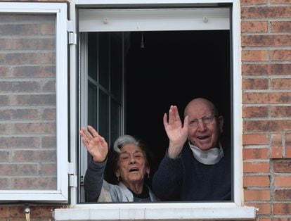 José and Guadalupe, wave from their home, after being discharged from hospital.