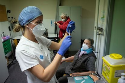 A health worker administers the first dose of the Pfizer Covid vaccine at a hospital in Barcelona.