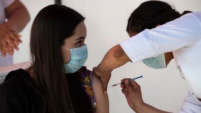A health worker gets a shot of the Pfizer-BioNTech vaccine in Mexico City on December 30.