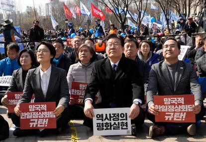 South Korea's main opposition Democratic Party leader Lee Jae-myung, center, takes part in a rally denouncing South Korean President Yoon Suk Yeol on March 18, 2023.