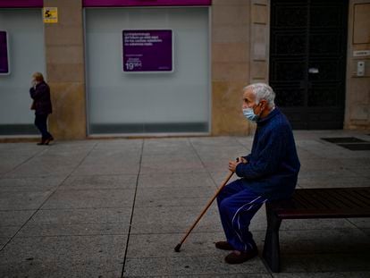 A man sits on a bench wearing a face mask to protect against coronavirus in Pamplona on Saturday.