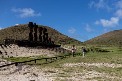 Two tourists are photographed in front of the moais of Anakena, on Easter Island, on August 5.
