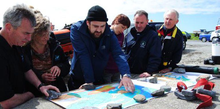 Historian John Treacy coordinates a search with a team of divers.