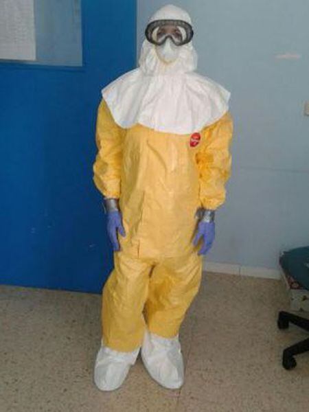 A healthcare worker who treated Miguel Pajares wearing a protective suit and gloves attached with duct tape.