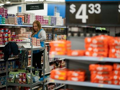A worker organizes items at a Walmart Supercenter in North Bergen, N.J., on Thursday, Feb. 9, 2023.