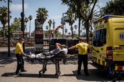 Paramedics help a patient into an ambulance during a heat wave in Barcelona, Spain, on Monday, July 18, 2022.