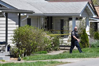 A Louisville Metro Police officer walks outside of the home of the suspected shooter in the Camp Taylor neighborhood in Louisville, Ky., Monday, April 10, 2023