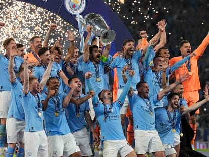 Manchester City's Ilkay Gundogan holds up the trophy after winning the Champions League final soccer match between Manchester City and Inter Milan at the Ataturk Olympic Stadium in Istanbul, Turkey, Sunday, June 11, 2023.