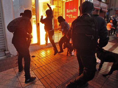 Hooded protestors set fire to a bank in Santiago during a Mapuche march on January 3.