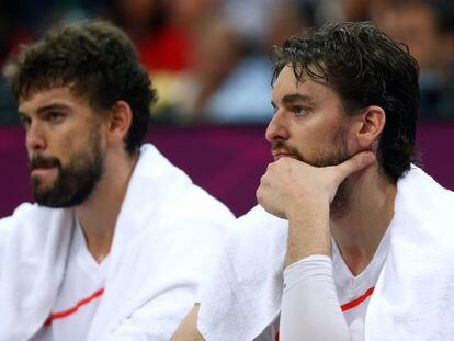 Marc Gasol (left) and Pau Gasol watch Spain&#039;s capitulation from the bench in London. 