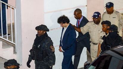 Samuel Bankman-Fried is escorted by police after being denied bail.