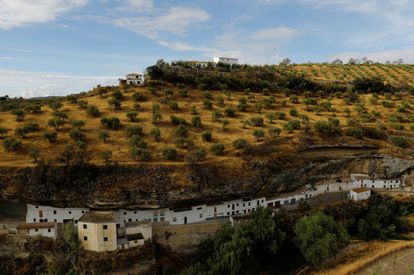 The white village of Setenil de las Bodegas, famous for its distinctive houses built into rock faces along a narrow river gorge.