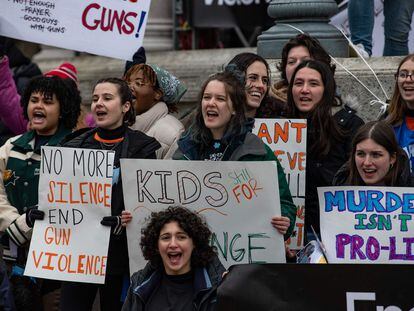 Demonstrators hold signs during an anti-gun violence rally in Boston, Massachusetts, on March 25, 2023.