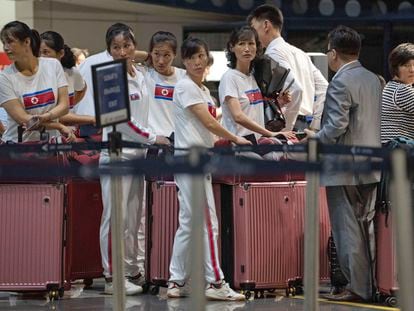 North Korean women line up for a flight to Astana at the Capital Airport in Beijing, Friday, Aug. 18, 2023.