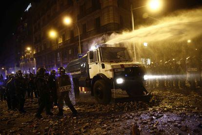 A water cannon is used by the regional police force, the Mossos d’Esquadra, against the protestors in Barcelona on Friday night.