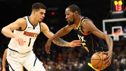 Kevin Durant (35) moves the ball against Denver Nuggets forward Michael Porter Jr. (1) in the first half at Footprint Center.