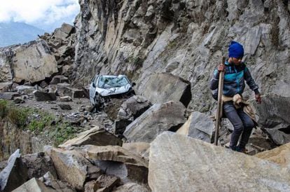 A Nepalese man walks over fallen rocks on the way to Dhunche, a village in Langtang National Park.