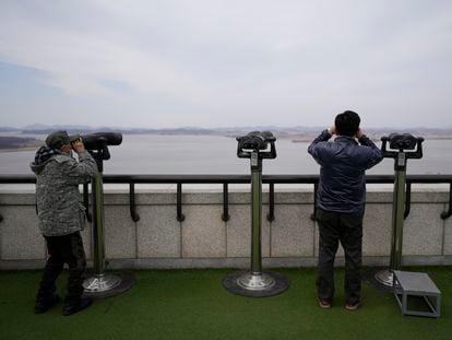 Visitors use binoculars to see the North Korean side from the unification observatory in Paju, South Korea, Tuesday, March 14, 2023.