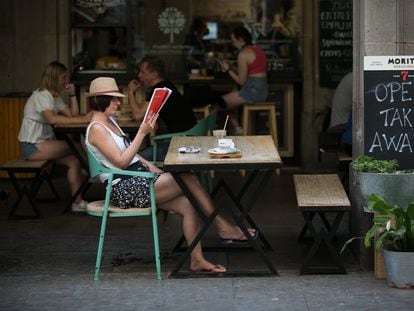 Customers at a sidewalk café in Barcelona's Plaza Real.