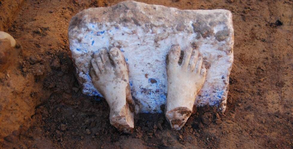The feet of a marble sculpture that originally came from the Aegean Sea.