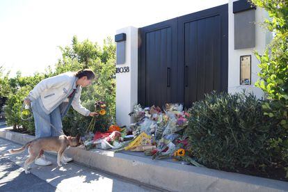 A person leaves flowers outside the home of late actor Matthew Perry in Pacific Palisades, California, U.S., October 31, 2023