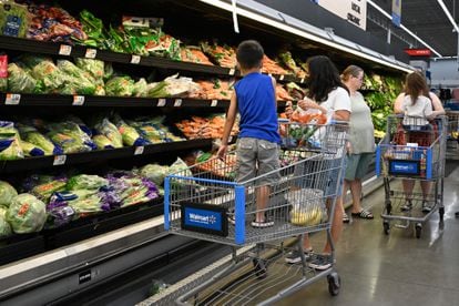Consumers shop in the produce section of a Walmart store in Burbank, California, on August 15, 2022.