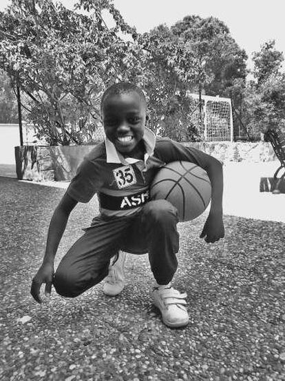 Adou in Ceuta playing with a basketball he has been given as a gift.