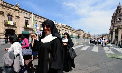 Nuns and other followers walk near the Cathedral in Morelia, Michoacán, ahead of the pope's visit.