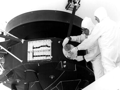 Two engineers install the Golden Disk on the 'Voyager probe,' in 1977.