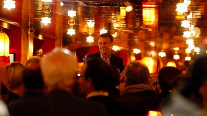 Emmanuel Macron is greeted by supporters inside La Rotonde restaurant in Paris in 2017.