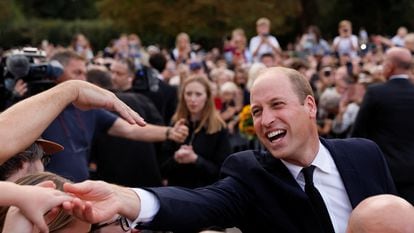 Prince William greets people gathered on Saturday around Windsor Castle.
