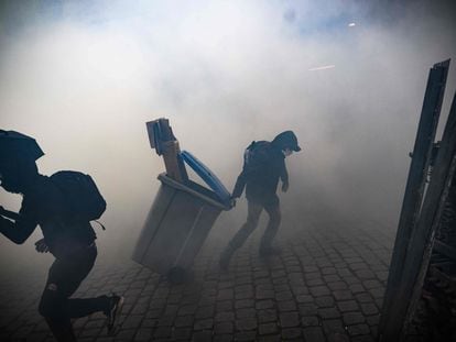 Protestors clash with police officers during a demonstration in Nantes, western France, on April 13, 2023.