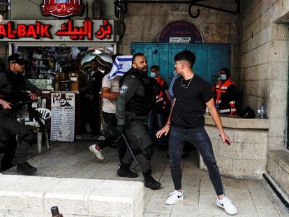 An Israeli border guard confronts a young Palestinian in Jerusalem, near the Damascus gate.