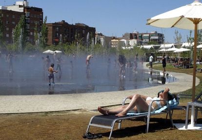 A woman sunbathes in Madrid Rio Park.